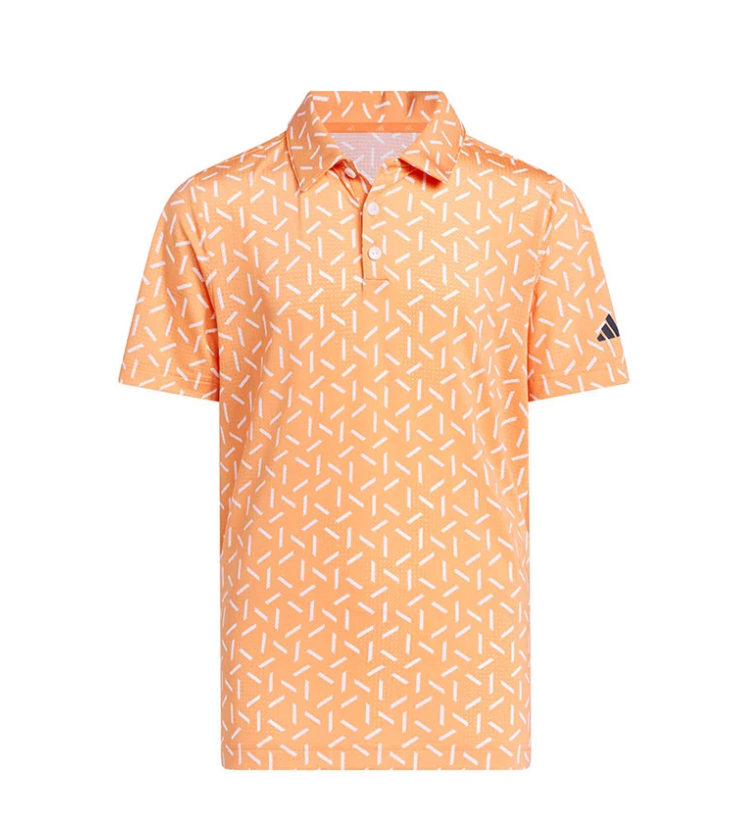 adidas junior short-sleeve peach orange golf polo shirt featuring an all-over white sprinkle pattern, a traditional collar with a button placket, and a dark adidas Three Bars logo on the left sleeve.