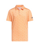 adidas junior short-sleeve peach orange golf polo shirt featuring an all-over white sprinkle pattern, a traditional collar with a button placket, and a dark adidas Three Bars logo on the left sleeve.